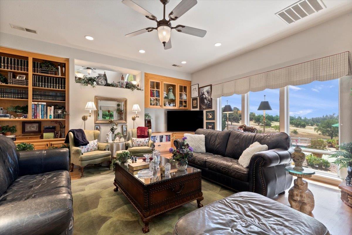 4558 Country View Court Cool, CA 95614 - Photo 36 of 71 a living room with furniture ceiling fan and a large window