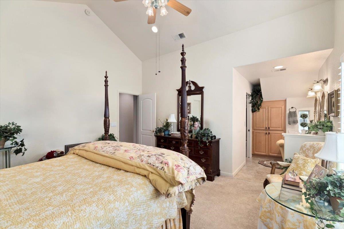 4558 Country View Court Cool, CA 95614 - Photo 37 of 71 a bed room with a bed and a chandelier