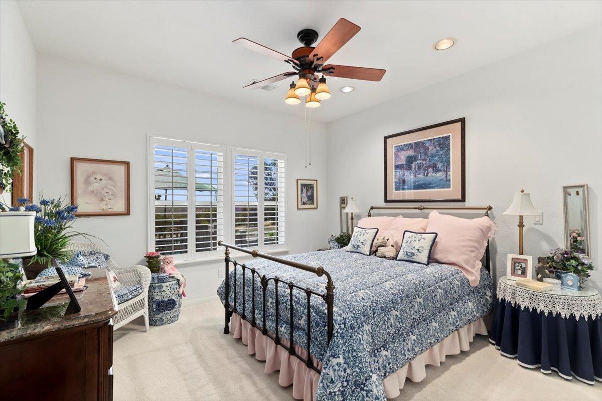4558 Country View Court Cool, CA 95614 - Photo 39 of 71 a bedroom with a bed and a large window with the potted plants