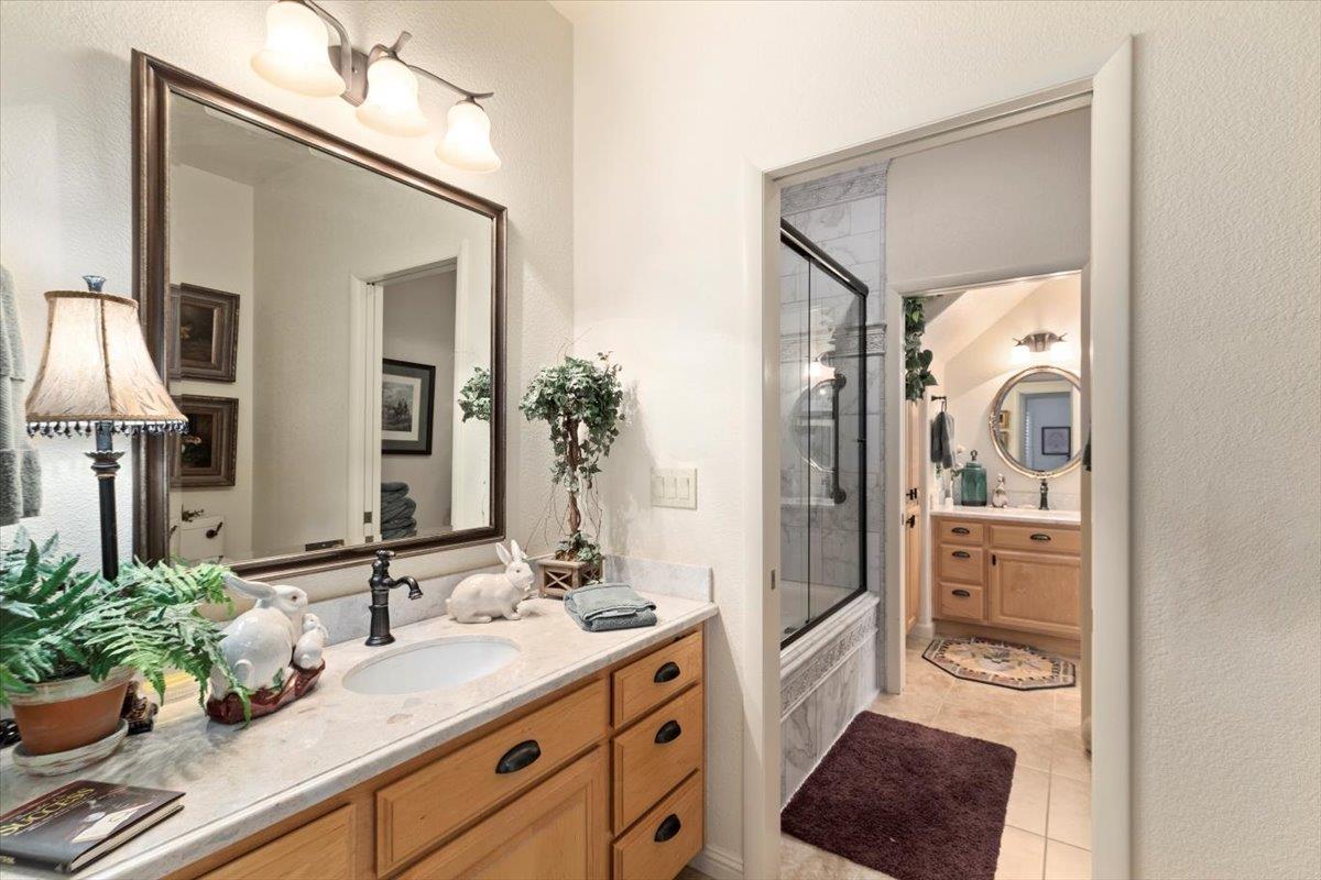 4558 Country View Court Cool, CA 95614 - Photo 40 of 71 a bathroom with a granite countertop sink and a mirror