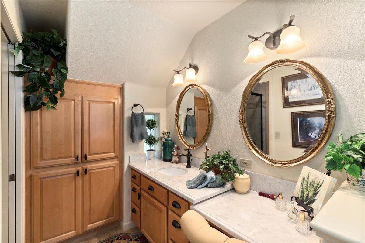 4558 Country View Court Cool, CA 95614 - Photo 42 of 71 a bathroom with a sink and a mirror