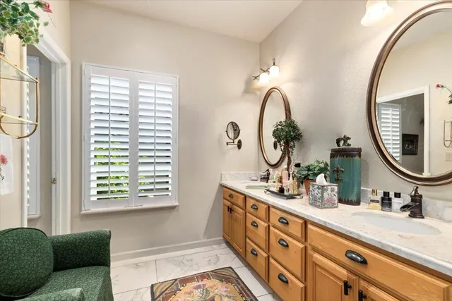 a backyard of a house with potted plants and garage