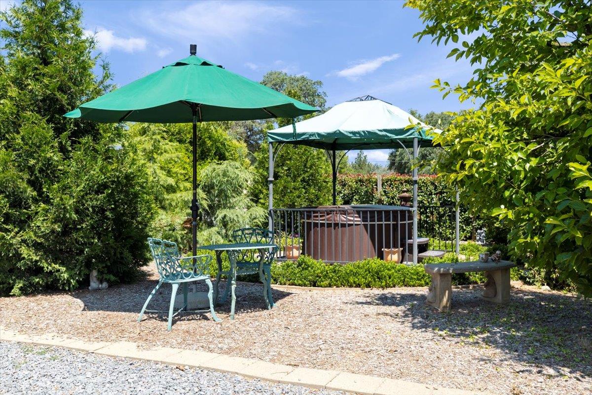 4558 Country View Court Cool, CA 95614 - Photo 54 of 71 a backyard of a house with table and chairs under an umbrella