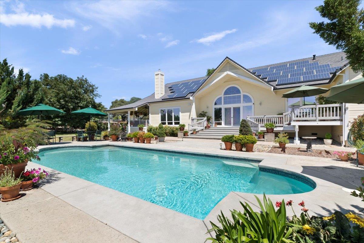 4558 Country View Court Cool, CA 95614 - Photo 8 of 71 a view of a house with swimming pool and sitting area