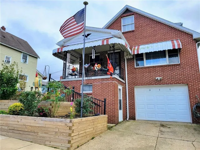 a view of a house with potted plants