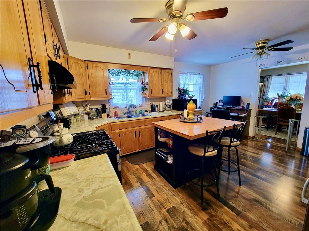 311 Elm Street Vandergrift, PA 15690 - Photo 12 of 47 a view of a dining room and kitchen with a table chairs a ceiling fan and a rug