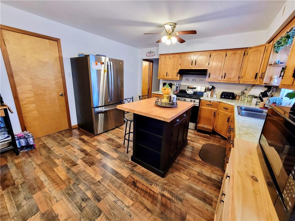 311 Elm Street Vandergrift, PA 15690 - Photo 13 of 47 a kitchen with stainless steel appliances granite countertop a sink refrigerator stove and microwave