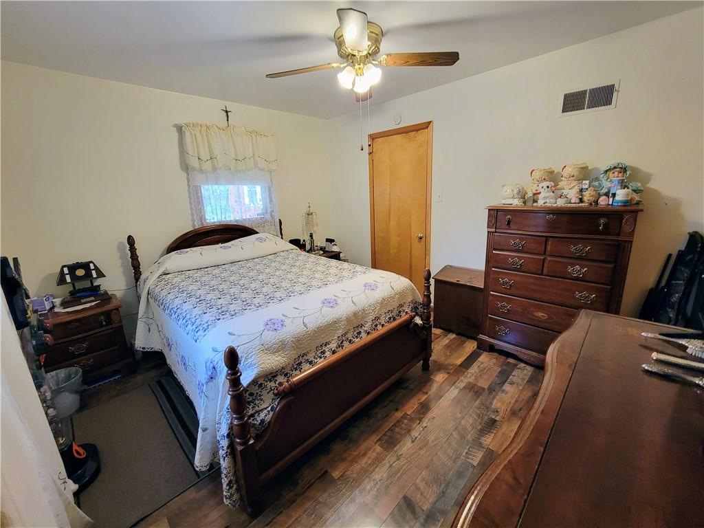 311 Elm Street Vandergrift, PA 15690 - Photo 17 of 47 a bedroom with a bed and a chandelier