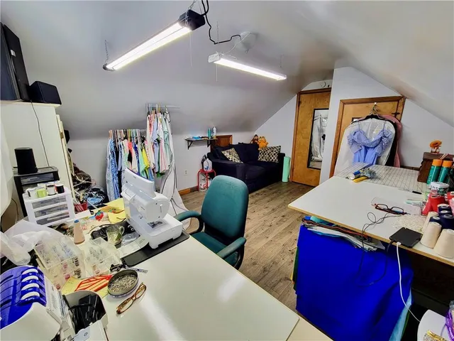 a view of a workspace with furniture and a window