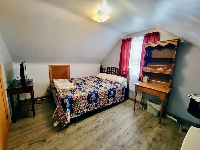a bedroom with a bed and a dresser in it