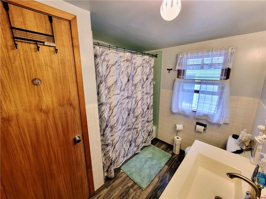 311 Elm Street Vandergrift, PA 15690 - Photo 26 of 47 a bathroom with a granite countertop sink and a shower