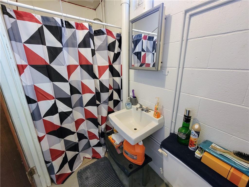311 Elm Street Vandergrift, PA 15690 - Photo 33 of 47 a bathroom with a sink a toilet and shower curtain