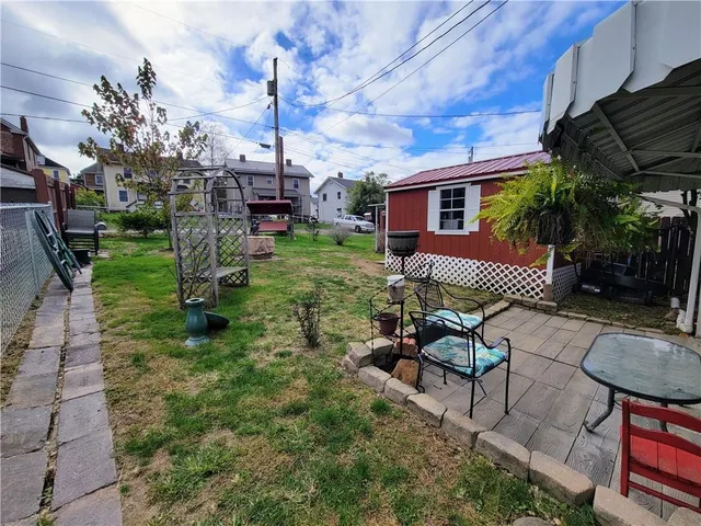 a view of a backyard with plants and flowers