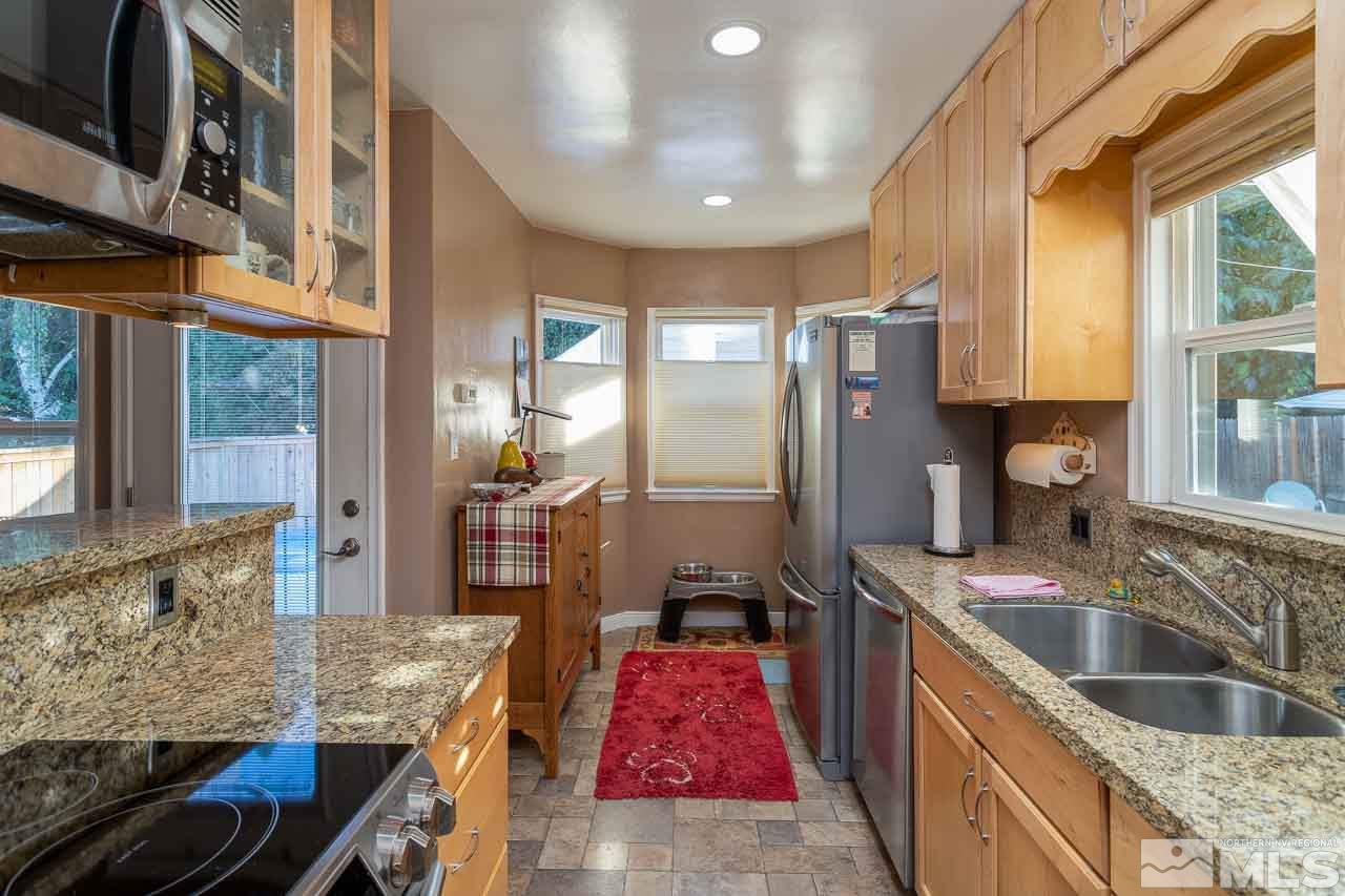 1011 Wright Street Reno, NV 89509 - Photo 11 of 21 a kitchen with stainless steel appliances granite countertop a sink stove and refrigerator