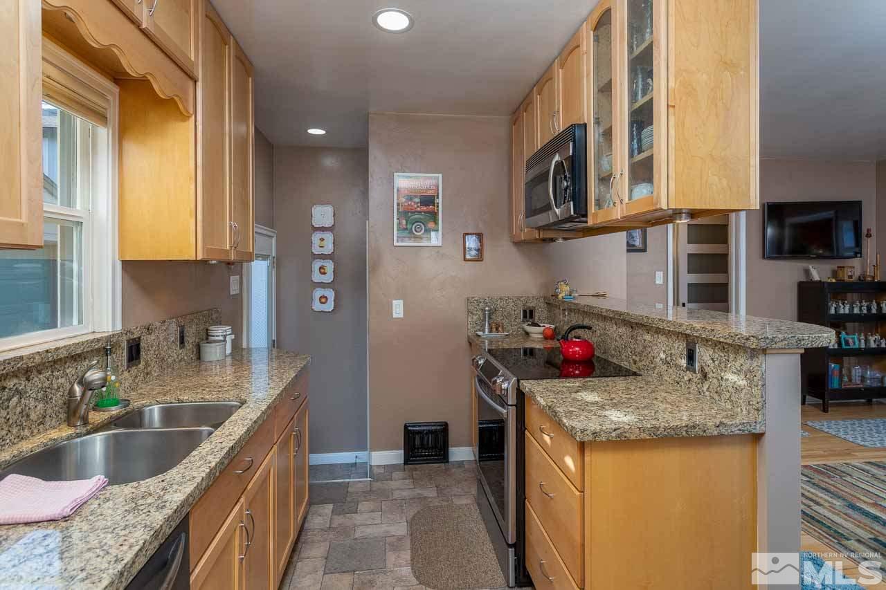 1011 Wright Street Reno, NV 89509 - Photo 12 of 21 a kitchen with stainless steel appliances granite countertop a sink stove and refrigerator