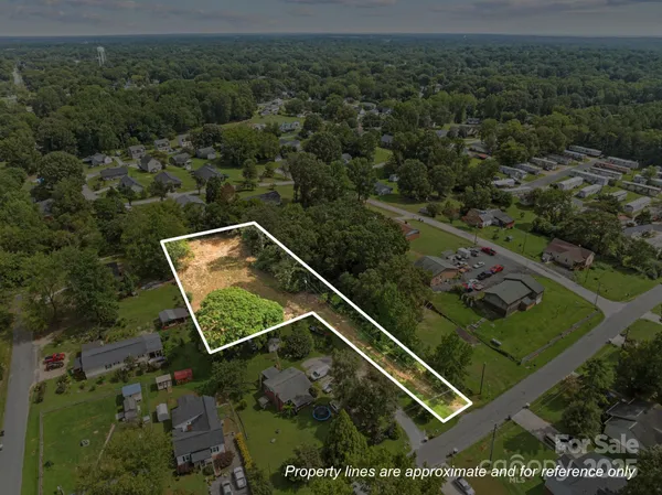 an aerial view of a residential house with a yard