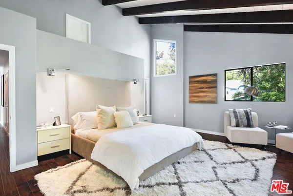 a bedroom with a bed and a couch