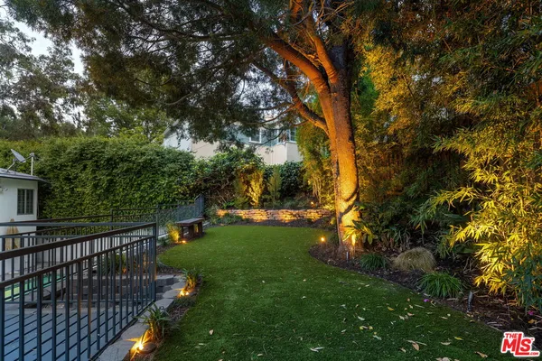 a view of backyard with swimming pool and green space