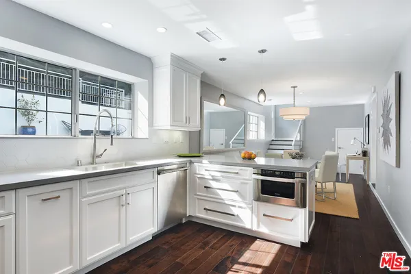 a kitchen with cabinets a sink and appliances