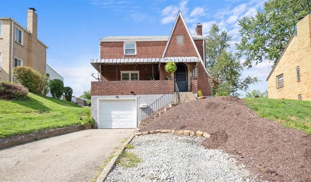 4746 Theodore Street Homestead, PA 15120 - Photo 1 of 25 a front view of a house with a yard