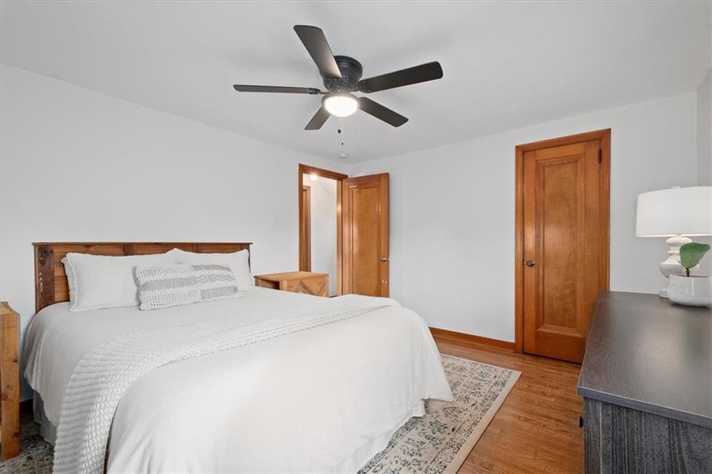 4746 Theodore Street Homestead, PA 15120 - Photo 15 of 25 a bedroom with a bed and wooden floor