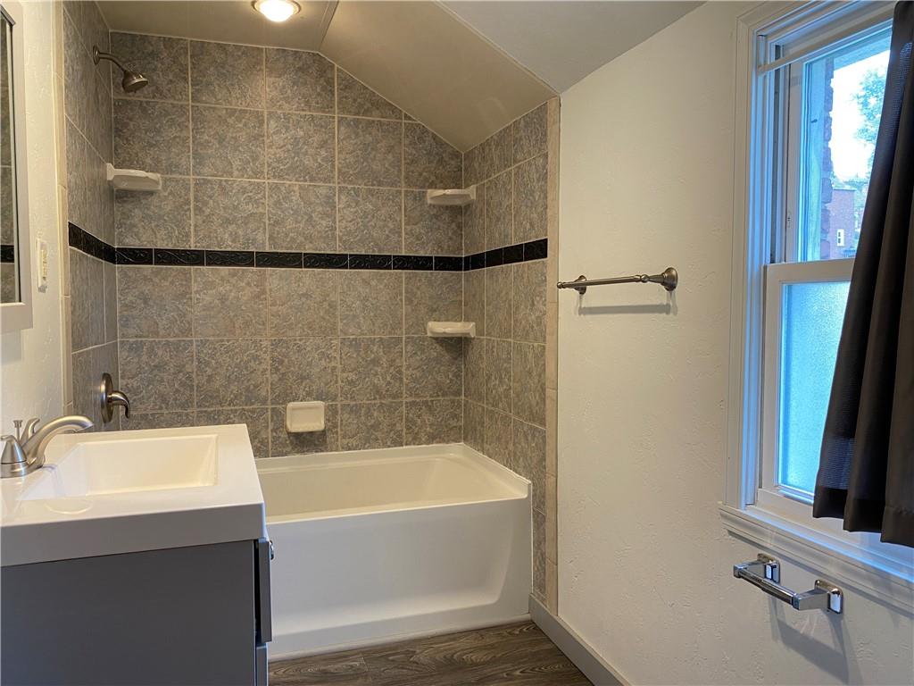 4746 Theodore Street Homestead, PA 15120 - Photo 17 of 25 a bathroom with a bathtub and a sink