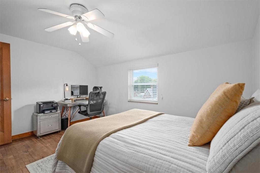 4746 Theodore Street Homestead, PA 15120 - Photo 19 of 25 a bedroom with a bed and a chandelier