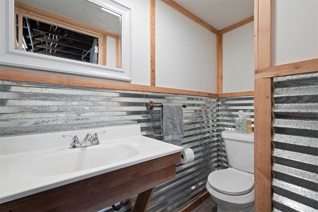 4746 Theodore Street Homestead, PA 15120 - Photo 22 of 25 a bathroom with a sink a toilet and shower