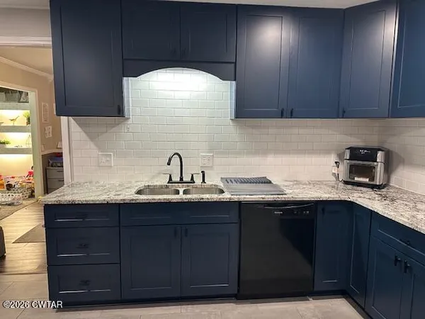 a kitchen with a sink and cabinets