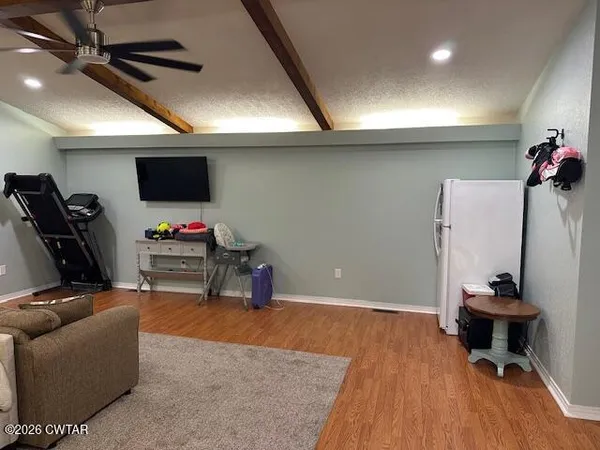 a room with a chair a mirror and rug