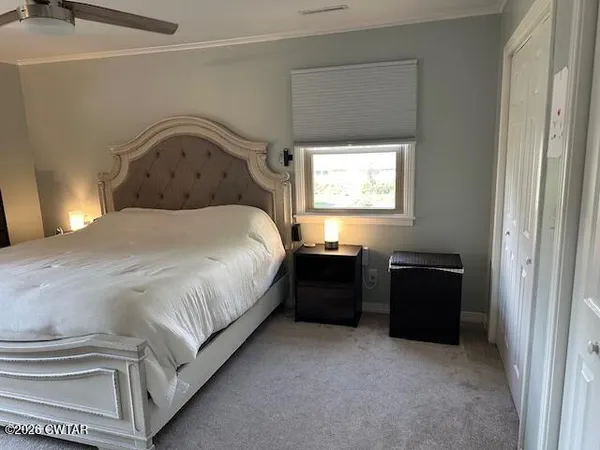 a bedroom with bed and a window