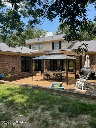 a front view of a house with swimming pool and sitting area