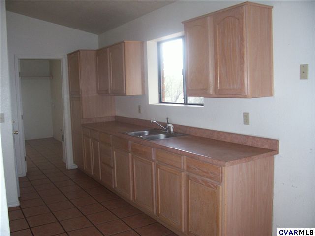 1271 Circulo Yerba Buena Rio Rico, AZ 85648 - Photo 4 of 10 a kitchen with a sink and cabinets