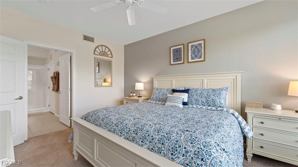9582 Hemingway Lane, Unit 3402 Fort Myers, FL 33913 - Photo 15 of 27 a bedroom with a large bed and a dresser