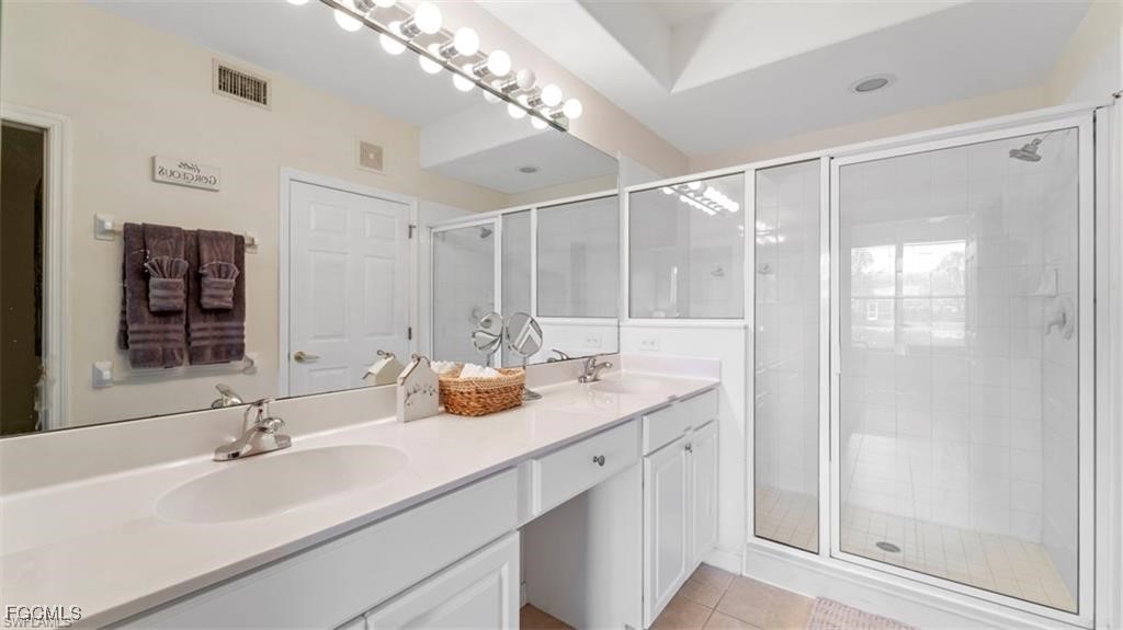 9582 Hemingway Lane, Unit 3402 Fort Myers, FL 33913 - Photo 16 of 27 a bathroom with a double vanity sink mirror and shower