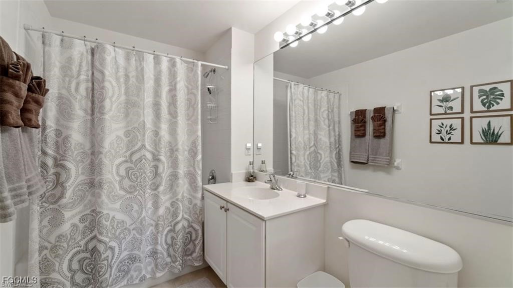 9582 Hemingway Lane, Unit 3402 Fort Myers, FL 33913 - Photo 18 of 27 a bathroom with a toilet sink and mirror