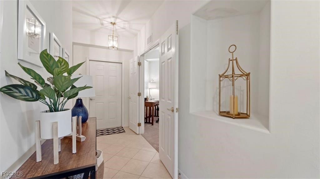 9582 Hemingway Lane, Unit 3402 Fort Myers, FL 33913 - Photo 2 of 27 a view of a hallway with paintings on the wall