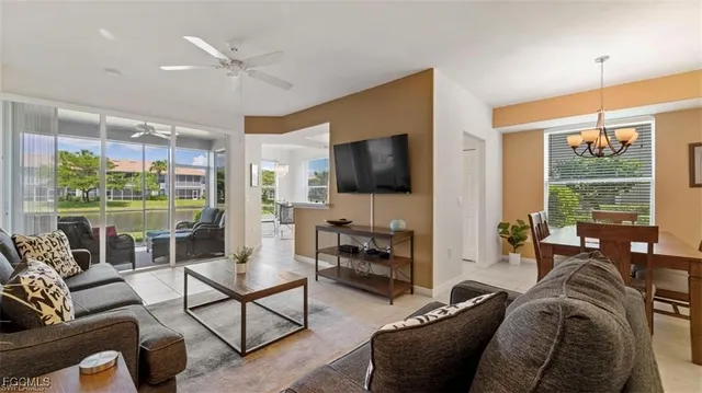 a living room with furniture a flat screen tv and a large window