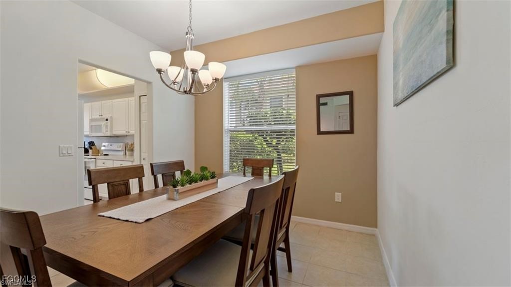 9582 Hemingway Lane, Unit 3402 Fort Myers, FL 33913 - Photo 6 of 27 a view of a dining room with furniture window and wooden floor