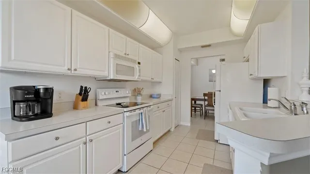 a kitchen with sink and cabinets