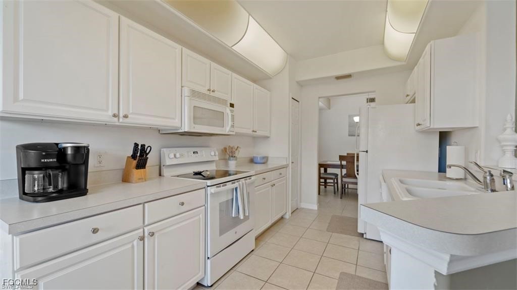 9582 Hemingway Lane, Unit 3402 Fort Myers, FL 33913 - Photo 9 of 27 a kitchen with sink and cabinets