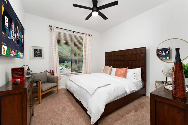 a bedroom with a bed and a window