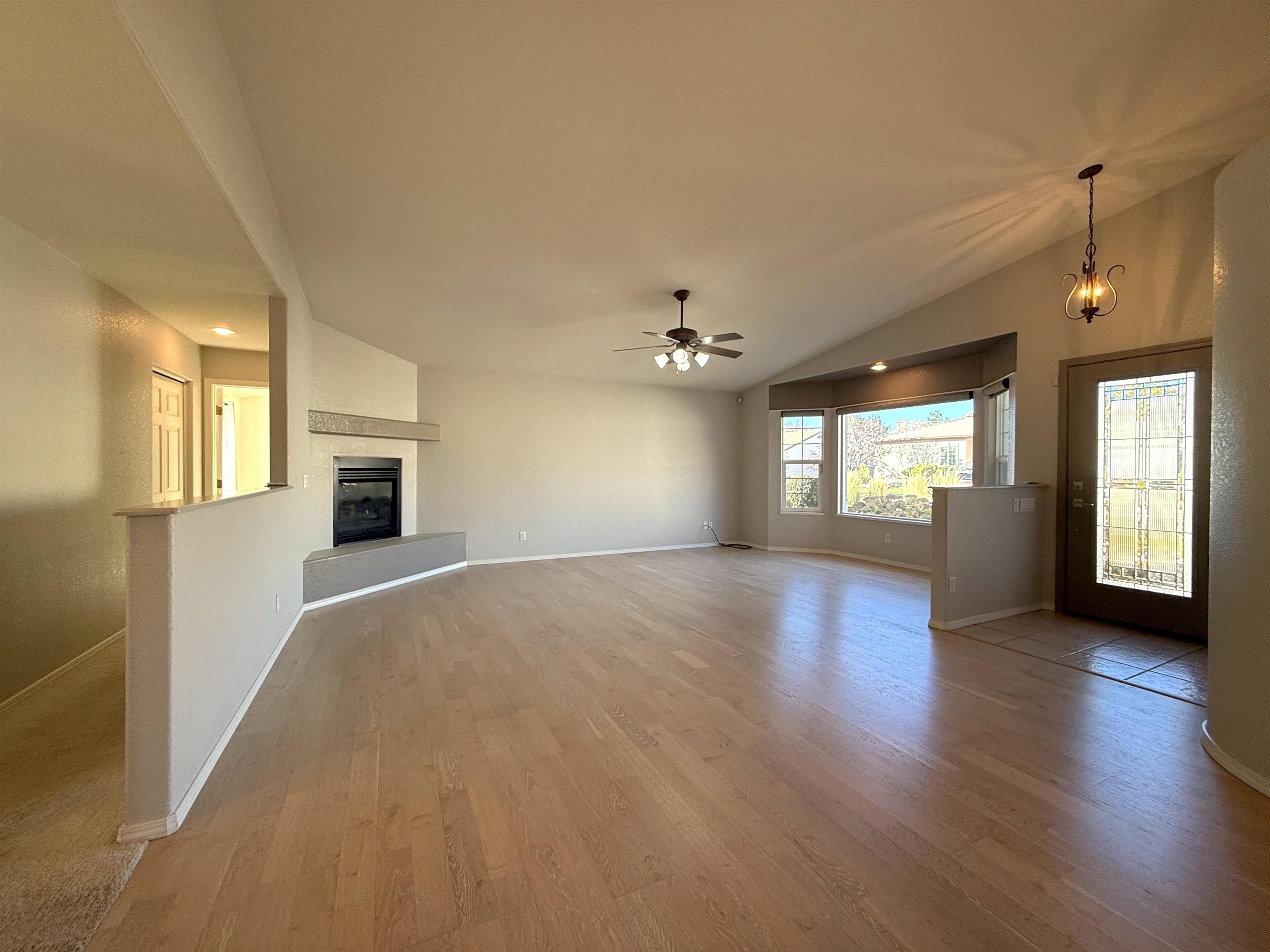 1459 Racquet Way Grand Junction, CO 81506 - Photo 11 of 42 a view of empty room with a fireplace and wooden floor