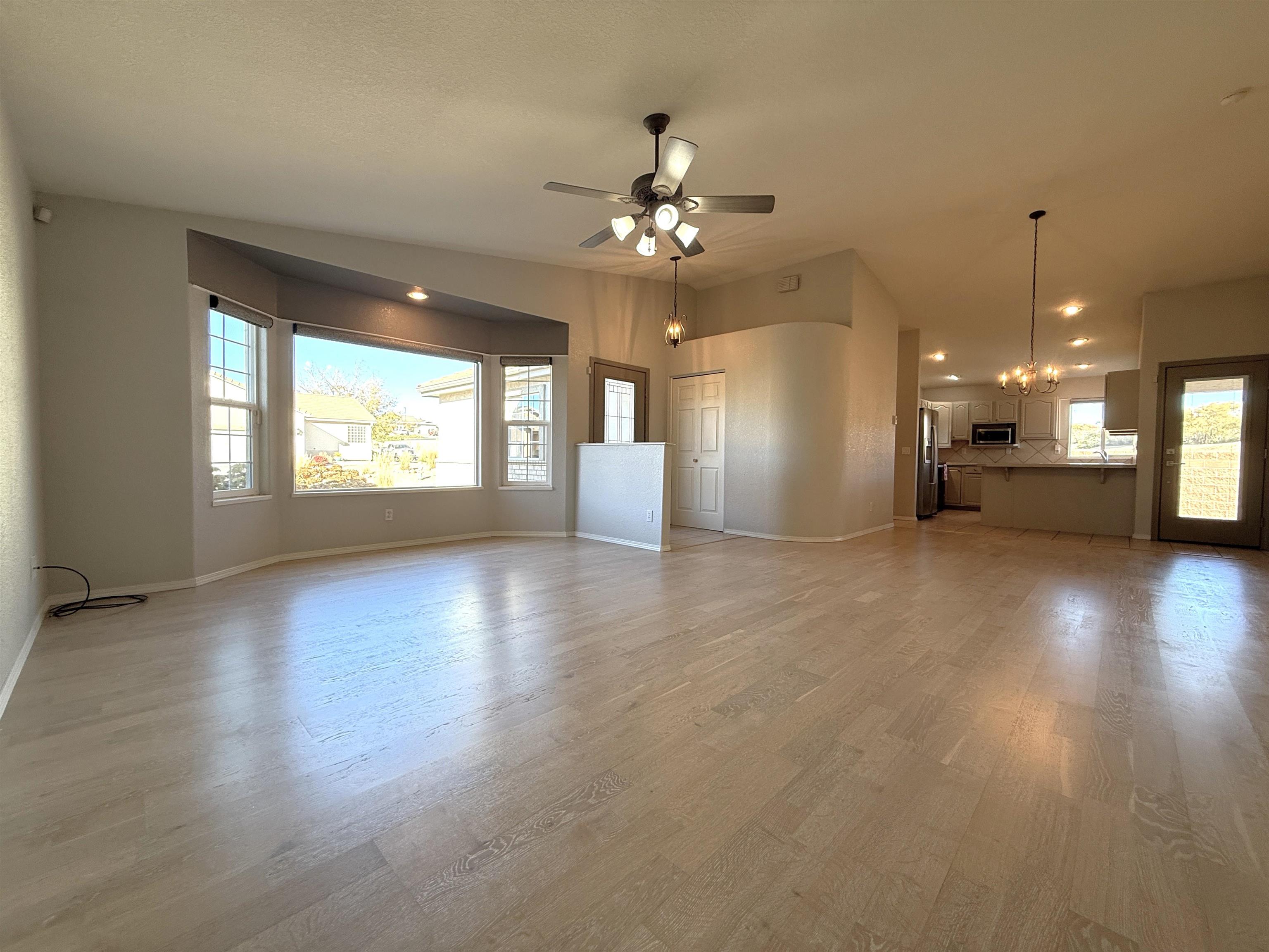 1459 Racquet Way Grand Junction, CO 81506 - Photo 12 of 42 an empty room with wooden floor and windows