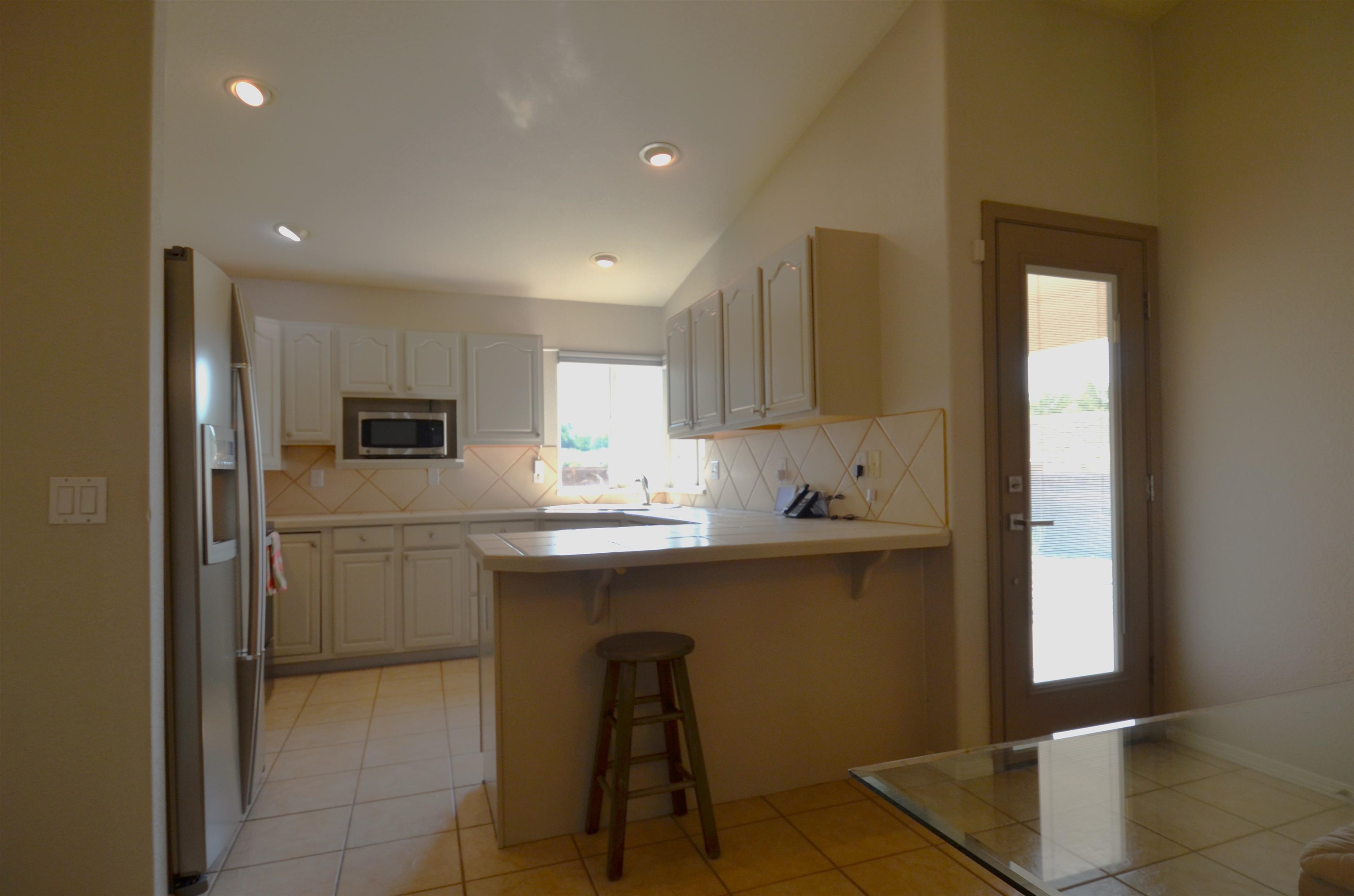 1459 Racquet Way Grand Junction, CO 81506 - Photo 16 of 42 a kitchen with kitchen island a sink appliances and cabinets