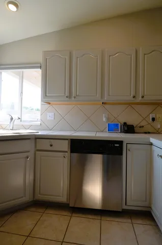 a kitchen with stainless steel appliances granite countertop a sink and a stove