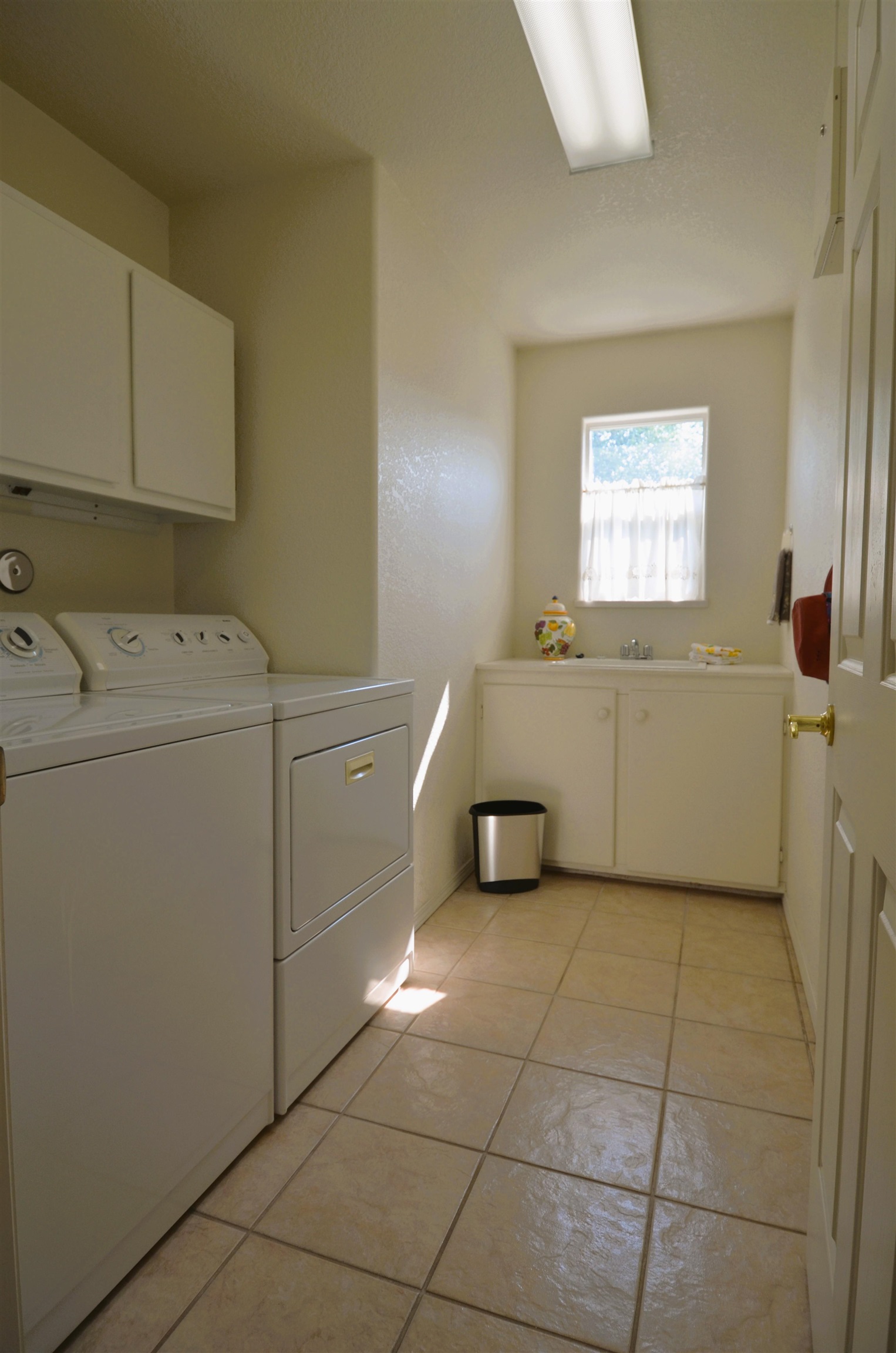 1459 Racquet Way Grand Junction, CO 81506 - Photo 24 of 42 a utility room with cabinets dryer and washer