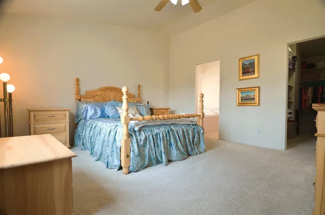 a bedroom with furniture and a flat tv screen