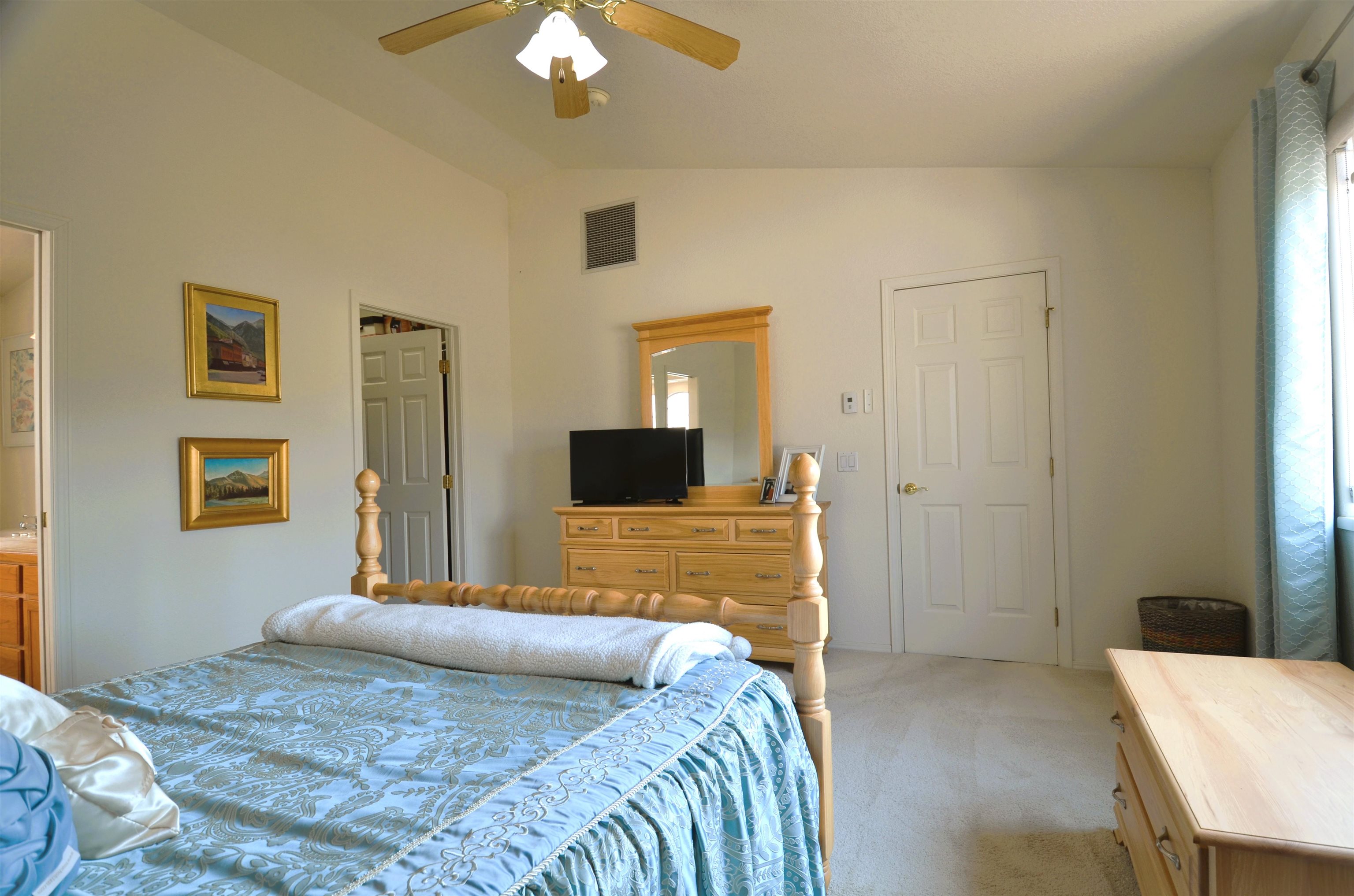 1459 Racquet Way Grand Junction, CO 81506 - Photo 27 of 42 a bedroom with a bed and a chandelier