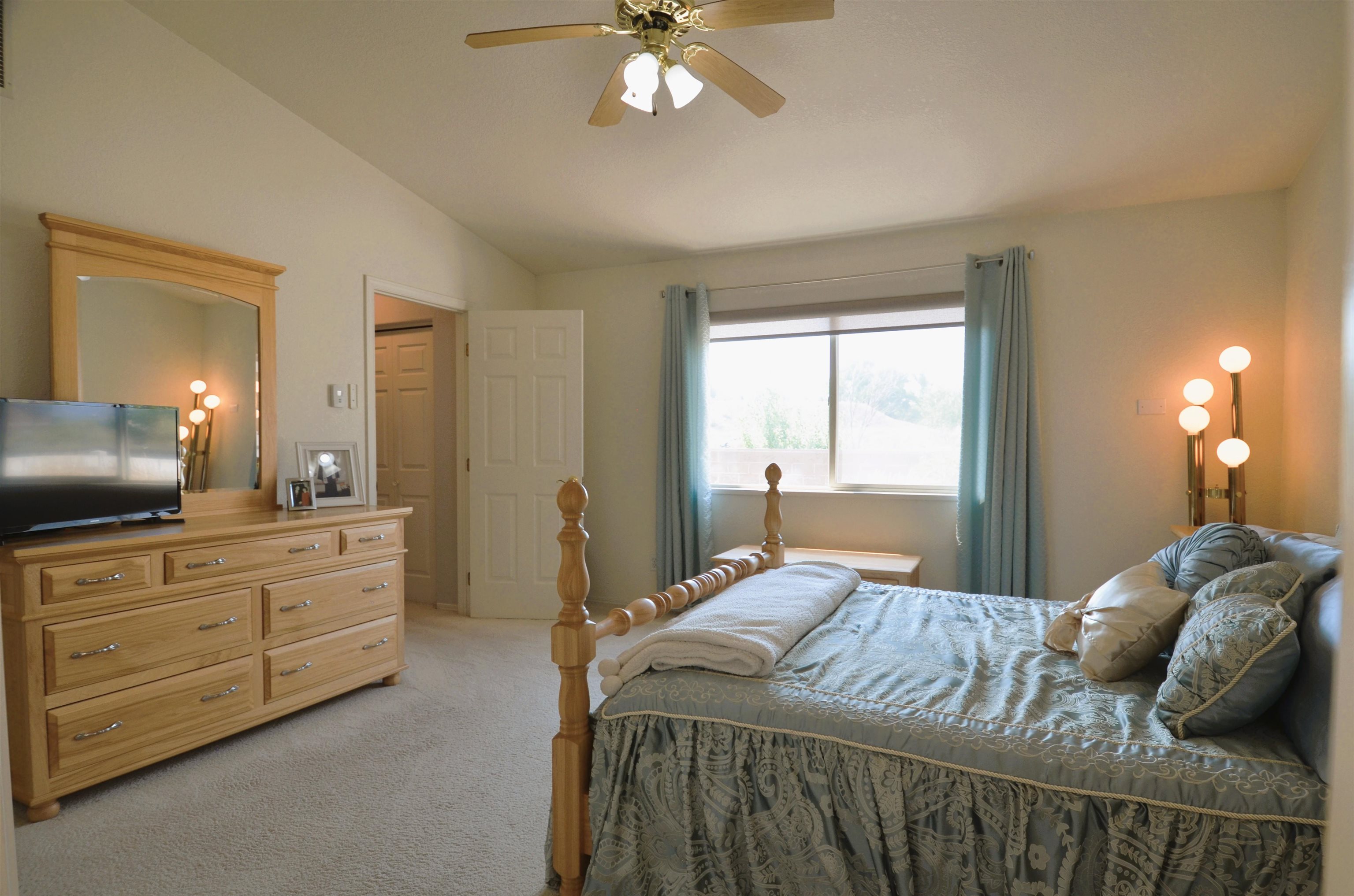 1459 Racquet Way Grand Junction, CO 81506 - Photo 28 of 42 a bedroom with a large bed and a chandelier